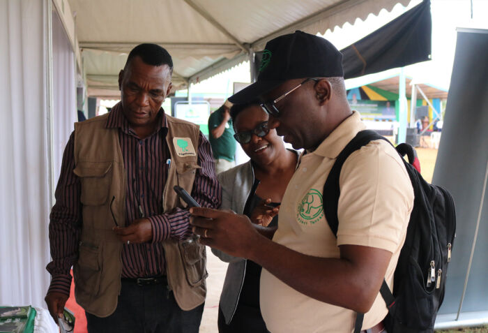 The Vi Agroforestry team, alongside a representative from the Illegal World Trade Project Tanzania, engages in dynamic discussions during the International Forests Day (IFD) celebration. 